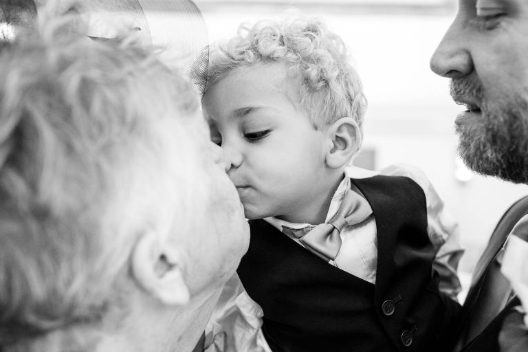 Little boy kisses grandmother