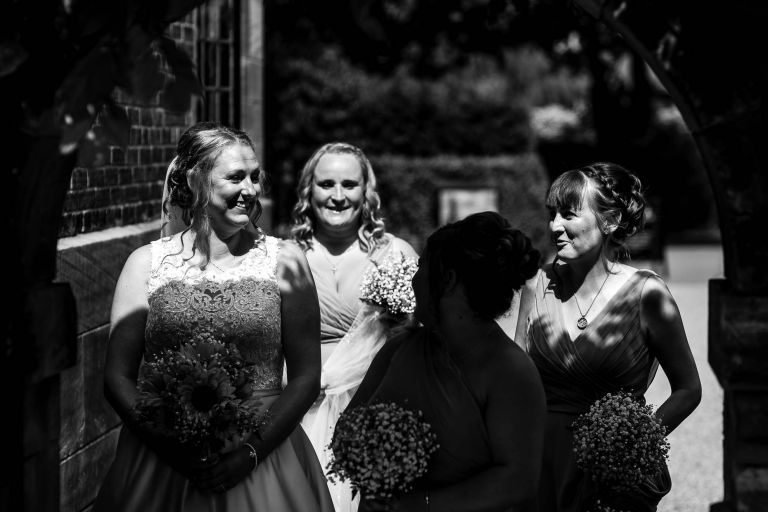 bride shares a joke with her bridesmaids