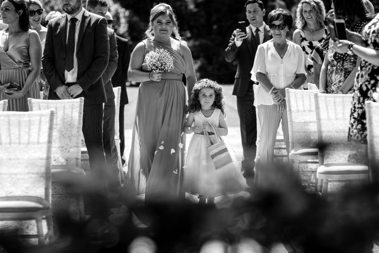 Flower girl looking anxious as she walks up the aisle