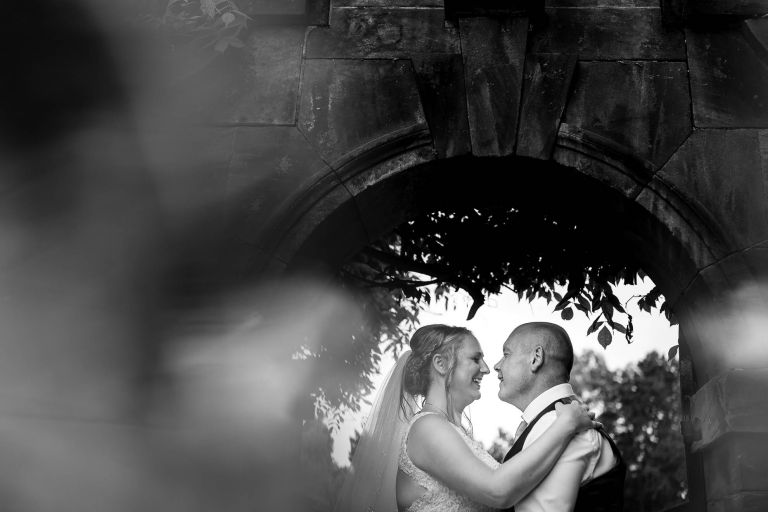 Bride and groom portrait under arch