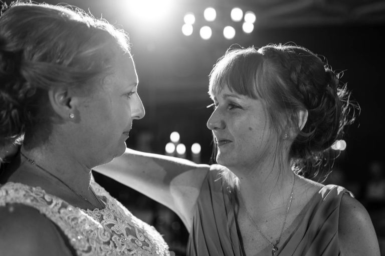 Bridesmaid and Bride share a moment