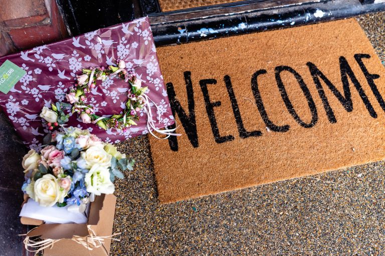 Welcome mat and bridal flowers