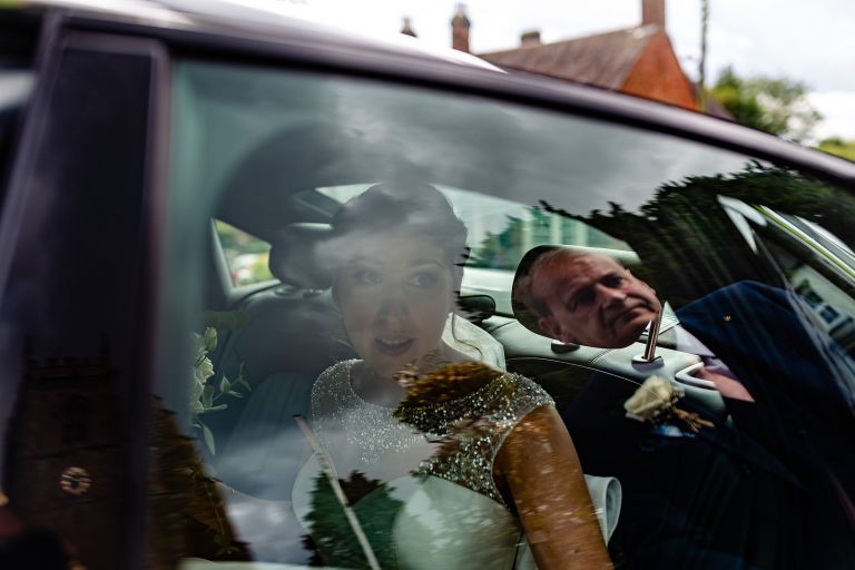Bride arrives at the wedding ceremony in the wedding car