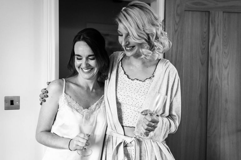 Bride and bridesmaid share a joke