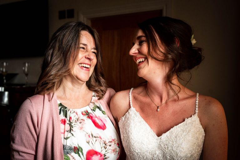 Bride and her mum share a joke