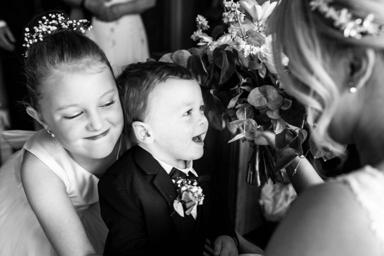 Brides son and daughter laugh with mum