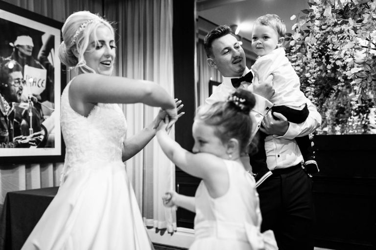 Bride and groom dance with their children