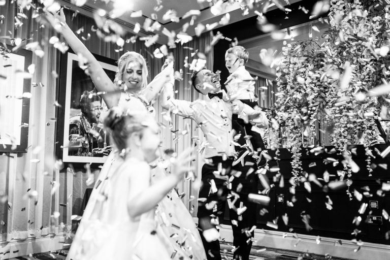 Bride and groom enjoying confetti bomb