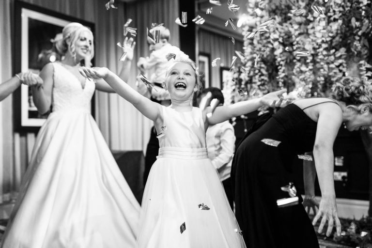 Flower girl playing with confetti