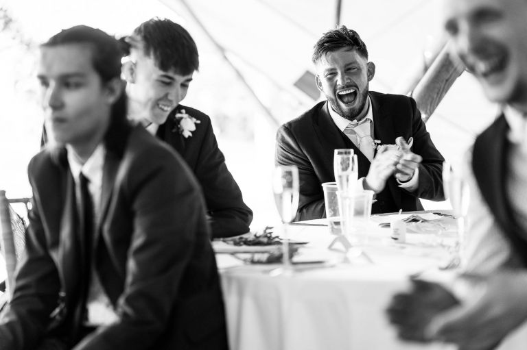 Guests laughing during best mans speech