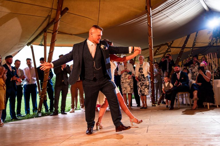 Bride and groom execute a dance move