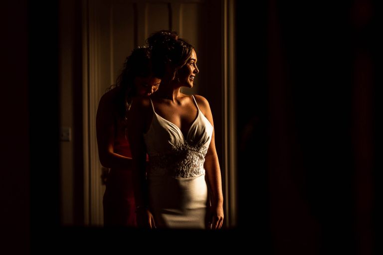 Bride in mirror hin her wedding dress
