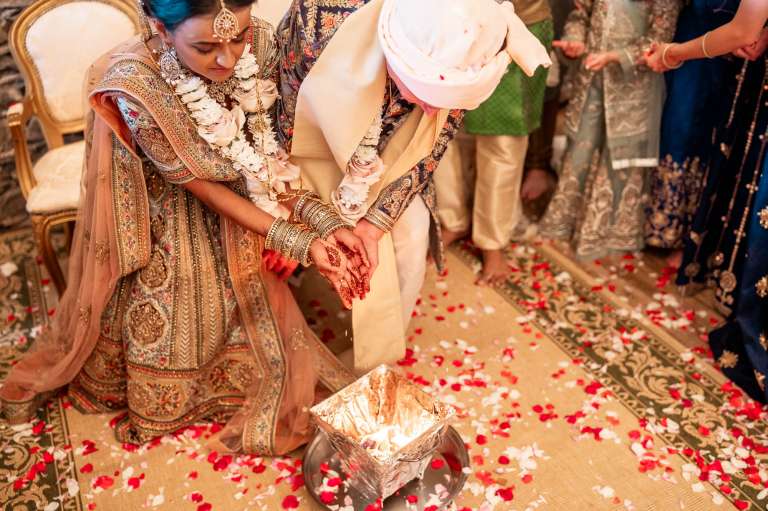 Bride and groom place rice into the fire