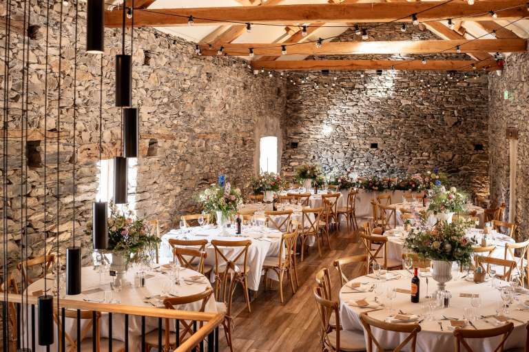 Wedding barn with tables set for wedding breakfast