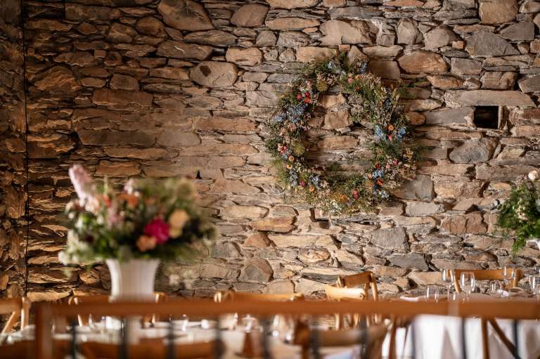Flower garland on wall of wedding barn