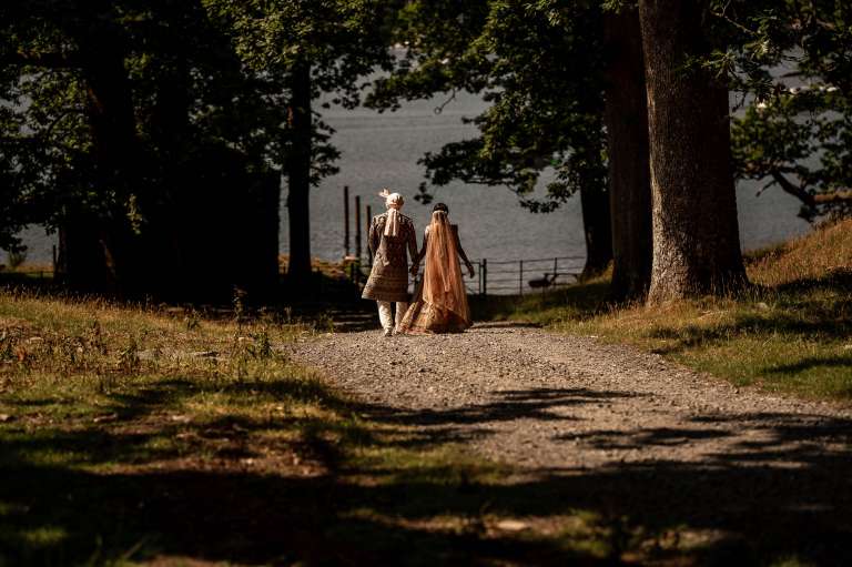 Newlyweds walk towards Lake Windermere