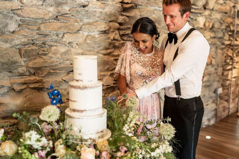 Bride and groom cut the wedding cake
