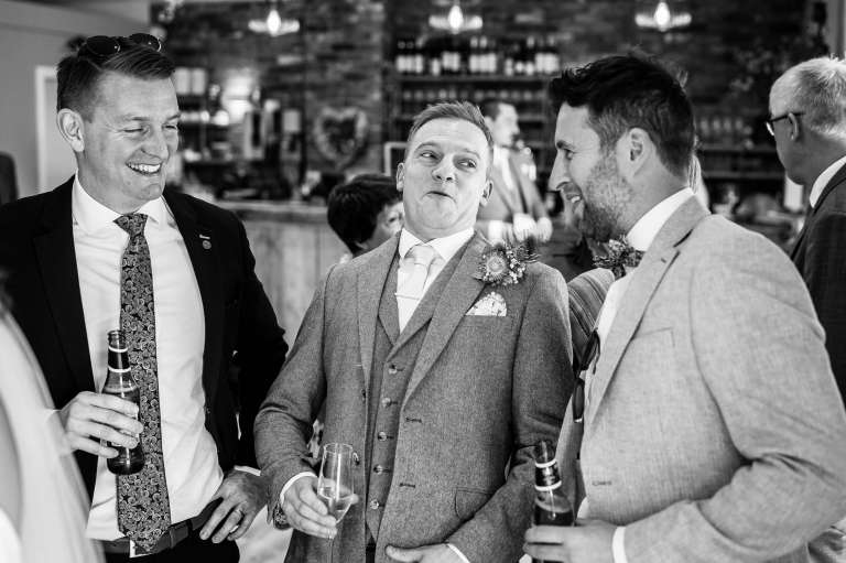 Groom shares a joke with guests