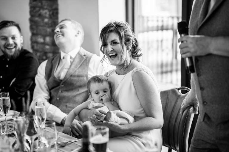 Bride laughs during father of the brides speech