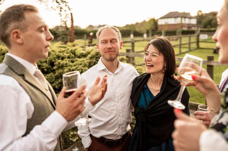 Groom chats to wedding guests