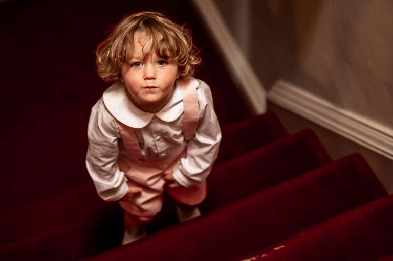 Portrait of page boy on stairs