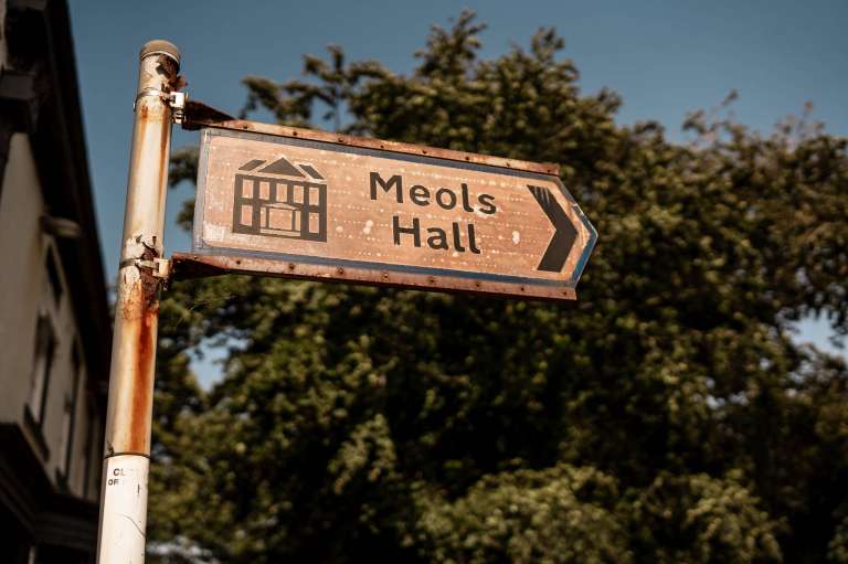 Road sign for Meols hall