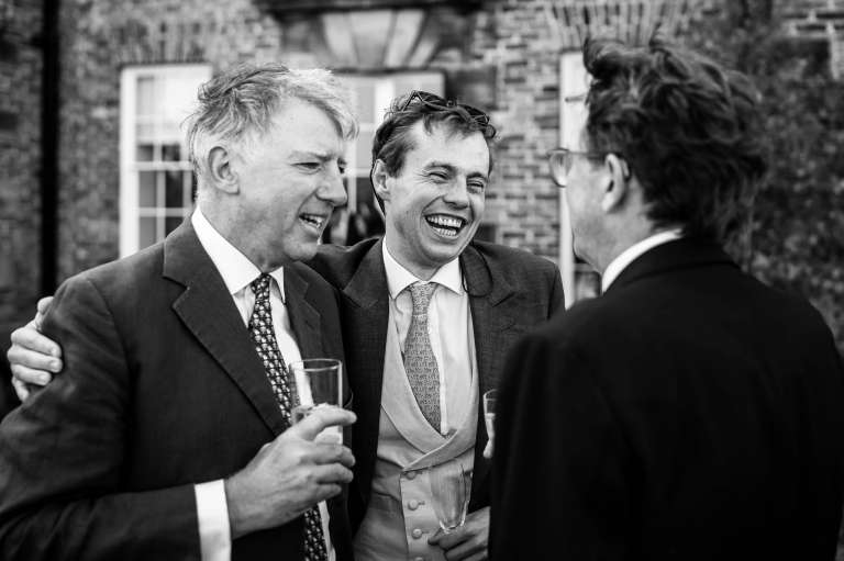 Guests share a joke during drinks reception