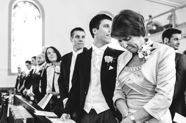 The mother of the bride is overwhelmed with emotion after seeing her daughter start her walk up the aisle