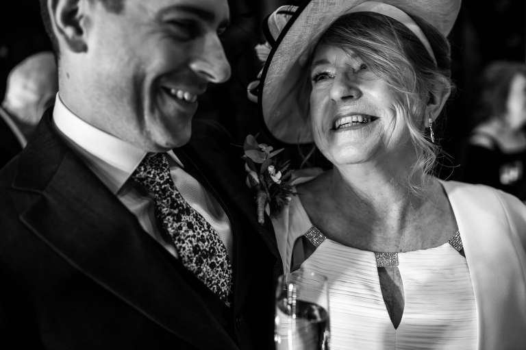Big smile from the mother of the groom after congratulating the groom during the drinks reception 