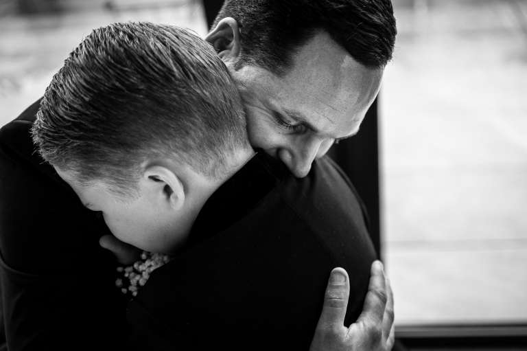 The groom hugs his son who was a little overwhelmed during the wedding ceremony
